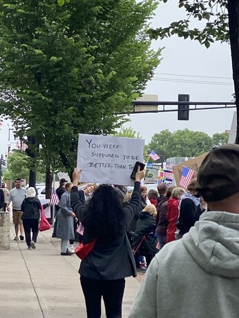 Her sign says "you were supposed to be better than this", both sides of the sign say it. Some folks were confused by her sign but it's clear to me she voted for the bastard & has regrets.