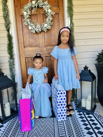 Two little girls in blue. On the left, the almost 3 year old is dressed as Cindarella, and on the right, the 7 year old is the “new” Ariel. 