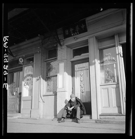 A black and white photograph depicting an elderly Asian man sitting on the steps of a building labeled "Sacramento Chinese Benevolent Association." The image captures the scene with clear contrast, emphasizing textures such as clothing wrinkles or wood grain. Additional context provided by captions indicates that this type represents those who historically worked in agriculture within California.