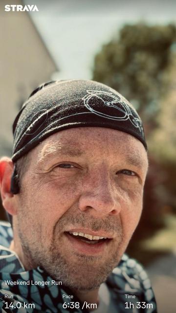 A close-up of me wearing a black headband, with a Strava fitness tracking overlay displaying details of a weekend run, including distance (14.0 km), pace (6:38/km), and time (1h 33m).