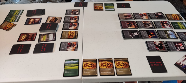 A tableau of cards from the game Heart Under Blade, laid out mid game.