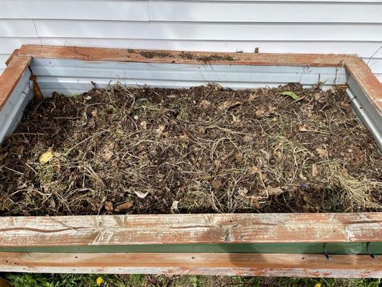 Can I put soil on top of compost that isn’t quite ready and plant something?