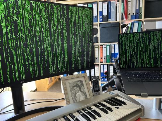 Floating matrix screensaver running on my MacBook Air and the 35’’ LG monitor hooked up to the Mac.