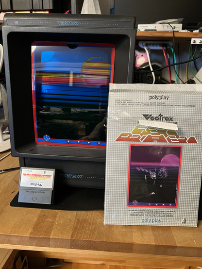 A vectrex console with the game box, the overlay and the cartridge