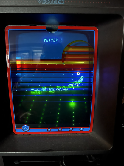 Game screen with a small space ship at the bottom, a pattern of enemy ships above, all happening on a dotted grid playfield