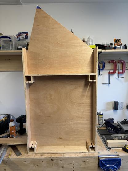 A part constructed model railway baseboard. It has five sides and three non-90 degree angles. Here three straight sides are dry fitted.