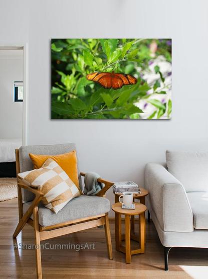 Orange Julia butterfly in a sea of green leaves photograph in a furniture setting by photographer Sharon Cummings.
