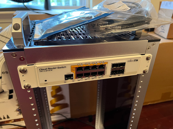 The Mikrotik CRS112-8P-4S-IN switch mounted in the top "slot" of the 12U minirack.