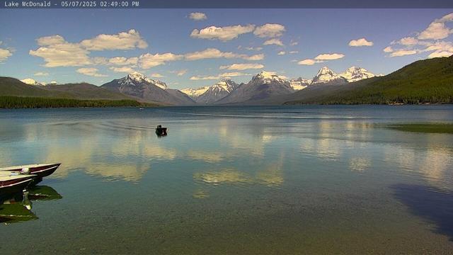 The calendar may say that it is still spring but the boats on Lake McDonald make this look a lot like a summer-time view today in Glacier National Park. Snow -capped mountains and puffy white clouds in a bright blue sky are reflected on the surface of the lake. Thanks to the National Park Service and the Glacier National Park Conservancy for providing these web camera images.