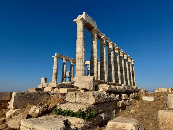 Temple of Poseidon - a white marble temple looking over the blue sea