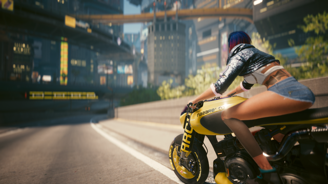 Cyberpunk 2077 in-game photos showing V on a motorcycle coming off the freeway and headed into Night City. The shots are from two different angles, left and right of V, but are similar overall. This is a shot from the left of V.