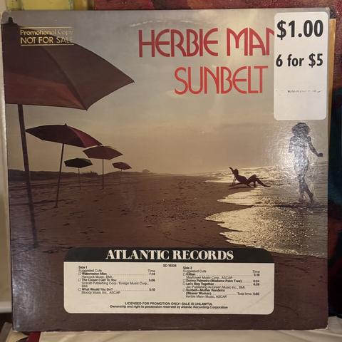 Front of a promo copy of Herbie Mann's "Sunbelt", featuring a very 1970s photo of a beach scape with two people silhouetted on it