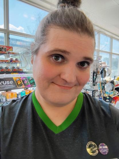 me at work with my "they/them" and "be kind always" pins on my shirt