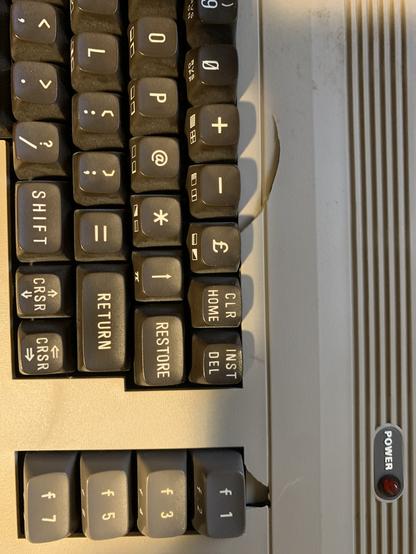 Right side, top view of the a C64 keyboard in the case . The right top most mounts have been cracked and shattered. Still intact and can be epoxied.