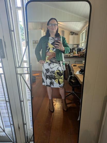Mirror selfie of me wearing the outfit in the flat lay.
