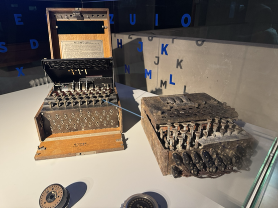 Two Enigma machines in a museum display case