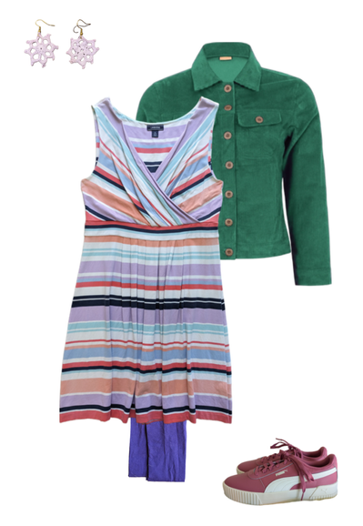 Flat lay of a femme outfit featuring a pastel rainbow striped dress over purple tights, paired with a green corduroy jacket and pink sneakers. Accessories include pale pink crochet earrings.