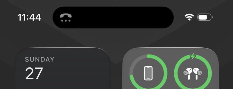 A screenshot of the top of an iOS 26 device showing a small grey phone icon with 3 dots underneath it in the dynamic island