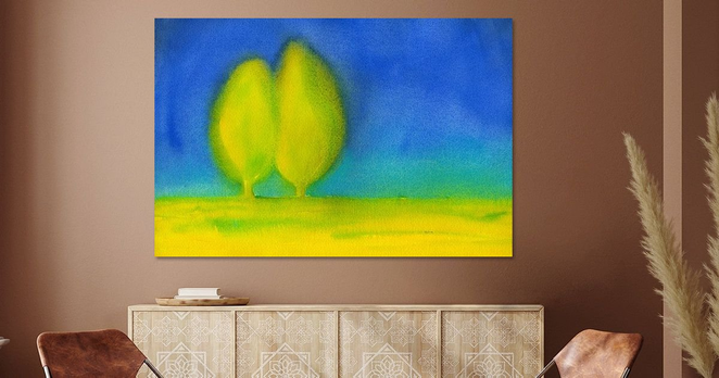 Two trees in love in a dreamy landscape is a watercolour painting in landscape format hand-painted by the artist Karen Kaspar.
Two trees stand close together in a field of vibrant yellow and green colours, perhaps a meadow with yellow spring flowers or a canola field in bloom, as if they were embracing each other like two lovers. The slender trees have bright yellow-green foliage and stand out against a bright blue background. The colors appear softly blurred, giving the scene a dreamlike, impressionistic quality.