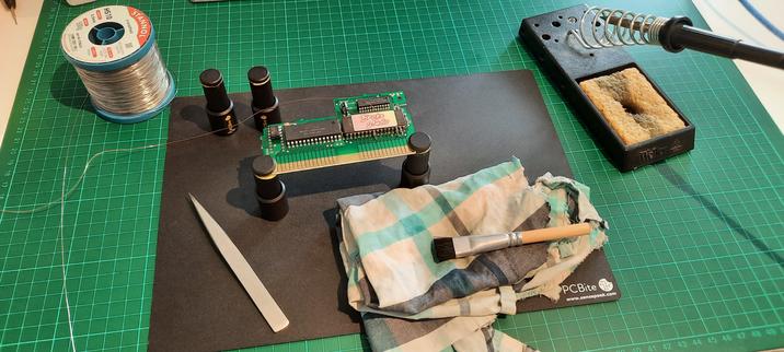 A work table where an old PCB is being rewired to work with the repurposed EPROM.