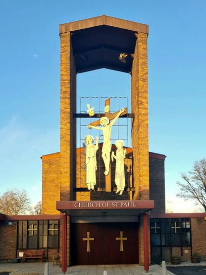 A modernist church in the east of Glasgow with a large depiction of Christ on the cross over the entrance.