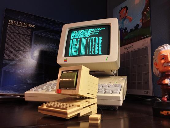 Apple //c computer on a desk with a LEGO Apple //c in the foreground