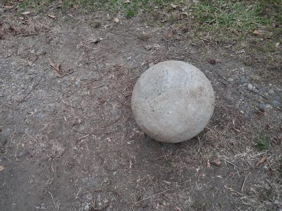 A cement sphere on the ground