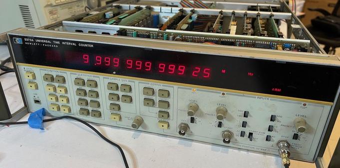 Electronic device with a huge number of red 9s on an LED display and lots of buttons that look soft rubber with really sexy rounded corners as well as BNC connectors and the top is open so you can see roughly ten circuit boards in the back