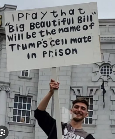 A protester holding a placard saying: “I Pray that Big Beautiful Bin" will be the name of Trump's cell mate in Prison.”