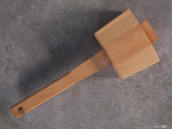 Beech wood mallet laying flat on a stone surface, viewed from the above.
