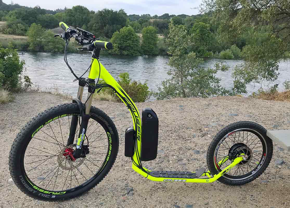 A standup bike that is been electrified. The battery is attached to the outside. Wheels are repairable.
