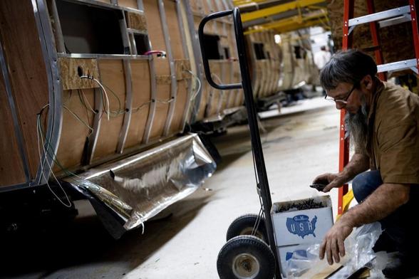 A worker opens boxes of screw at Riverside RV, builders of recreational vehicles, on January 24, 2020 in LaGrange, Indiana.