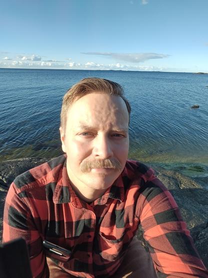 Self portrait against a sea view