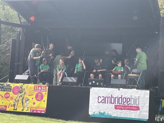 Many folk musician crowding into a stage.