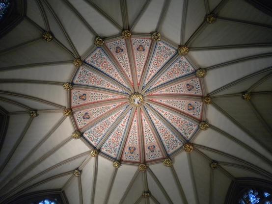 Octagonal ribbed vaulted ceiling with a gold boss at center. Around the boss are panels with blue and red floral designs extending a few meters in radius.