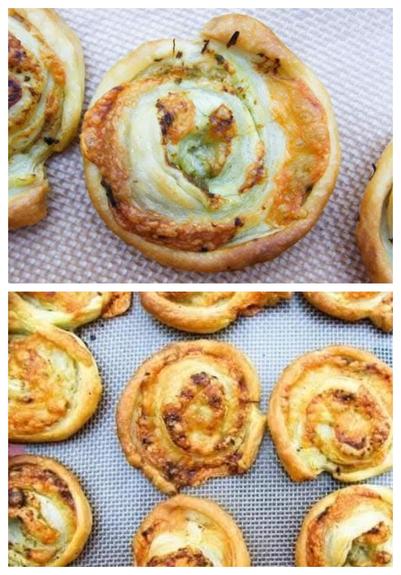 Pesto cheese puff pastry swirls on a baking sheet.