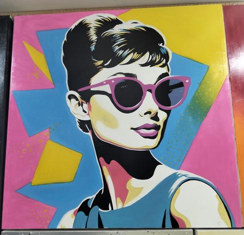 a painting of audrey hepburn, wearing pink sunglasses, her hair pinned up seen from her chest up, she is looking to the right, irregular regions of yellow and blue and pink are behind her, she wears a blue dress