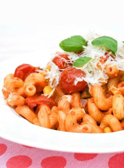 Spiral pasta in a sweet cherry tomato sauce with corn and herbs.