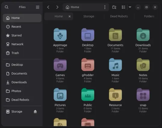 Shows a window on the Linux Desktop. The side panal lists places. The main window contains multicoloured rounded folders with various icons in the centre.