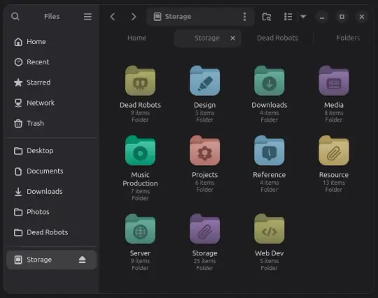 Shows a window on the Linux Desktop. The side panal lists places. The main window contains multicoloured rounded folders with various icons in the centre.