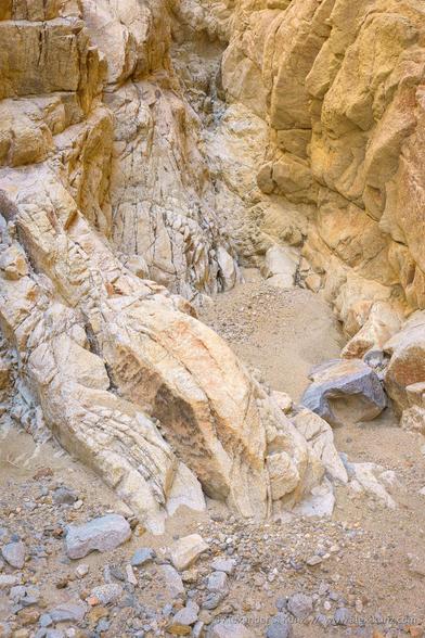 Photo of a rugged and rocky desert canyon with soft and warm colored sandstone.