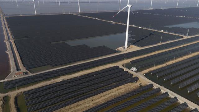 Wind turbines dot the coast line along a giant solar farm near Weifang in eastern China's Shandong province on March 22, 2024. (AP Photo/Ng Han Guan, File)