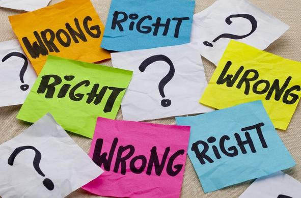 Crumpled notes in various colors show the words “right” and “wrong,” alongside question marks, symbolizing decisions and uncertainty.