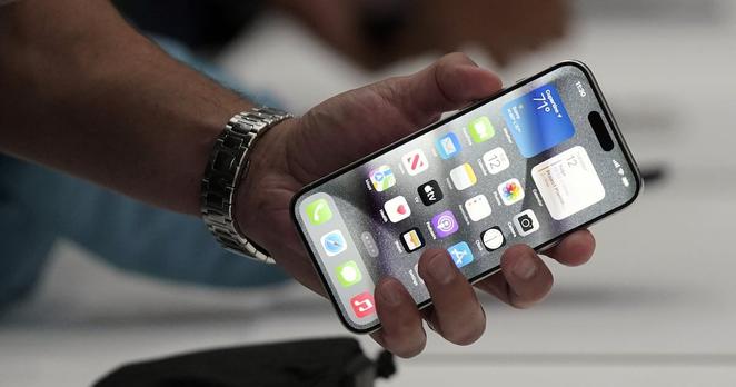 A person holds an iPhone 15 Pro at the Apple campus in Cupertino, Calif. (AP Photo/Jeff Chiu, File)