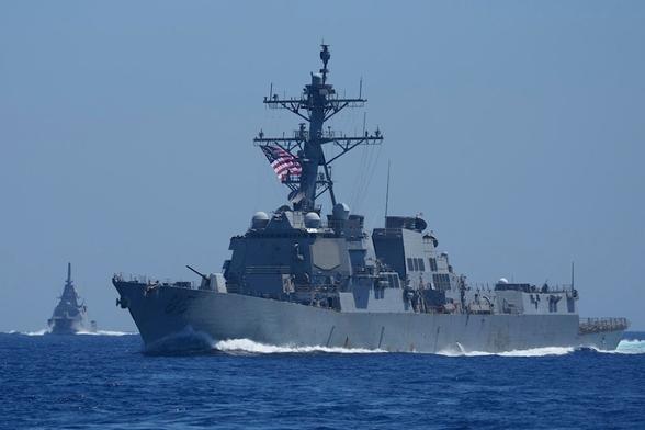 A US Navy USS Shoup (DDG86), right, and Japanese Maritime Self-Defence Force (JMSDF) frigate JS Noshiro off a disputed South China Sea shoal on Friday, March 28, 2025 (AP)