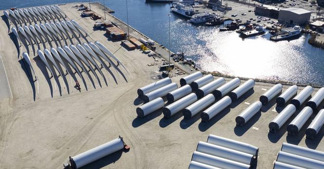 Rotor blades and tower sections for the Revolution Wind offshore turbine farm on a pier in New London, Conn., in November.