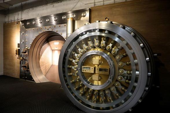 Large open bank vault door symbolizing secure bitcoin storage