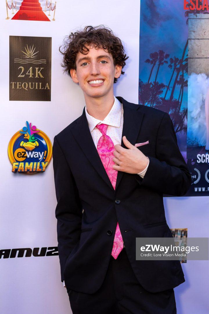Aiden McNally attending a red carpet media event as a teen nonprofit founder of Relief Alliance