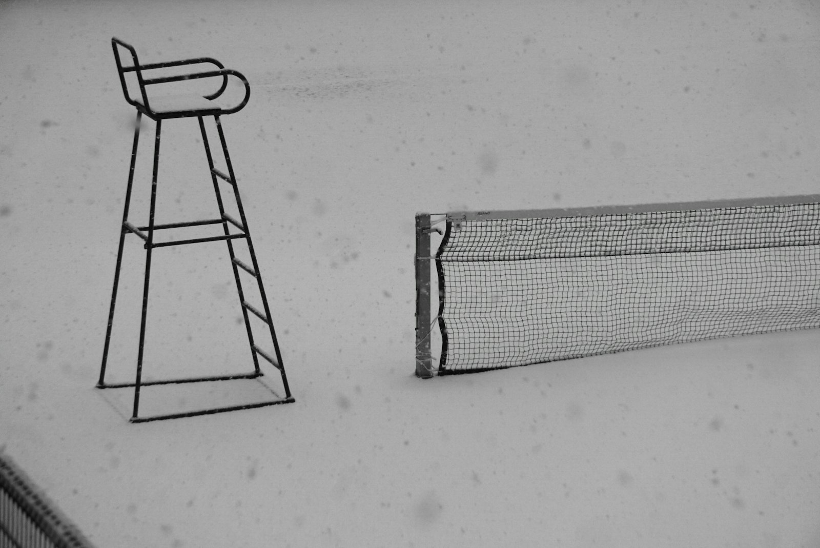 a black and white photo of a racket and a chair
