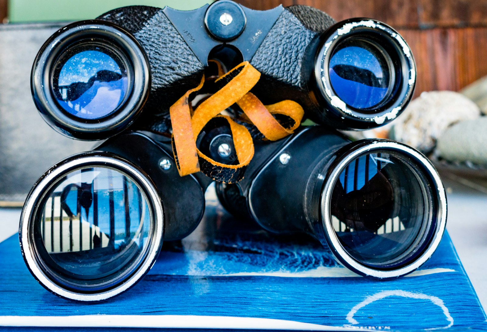 A pair of binoculars sitting on top of a blue mat